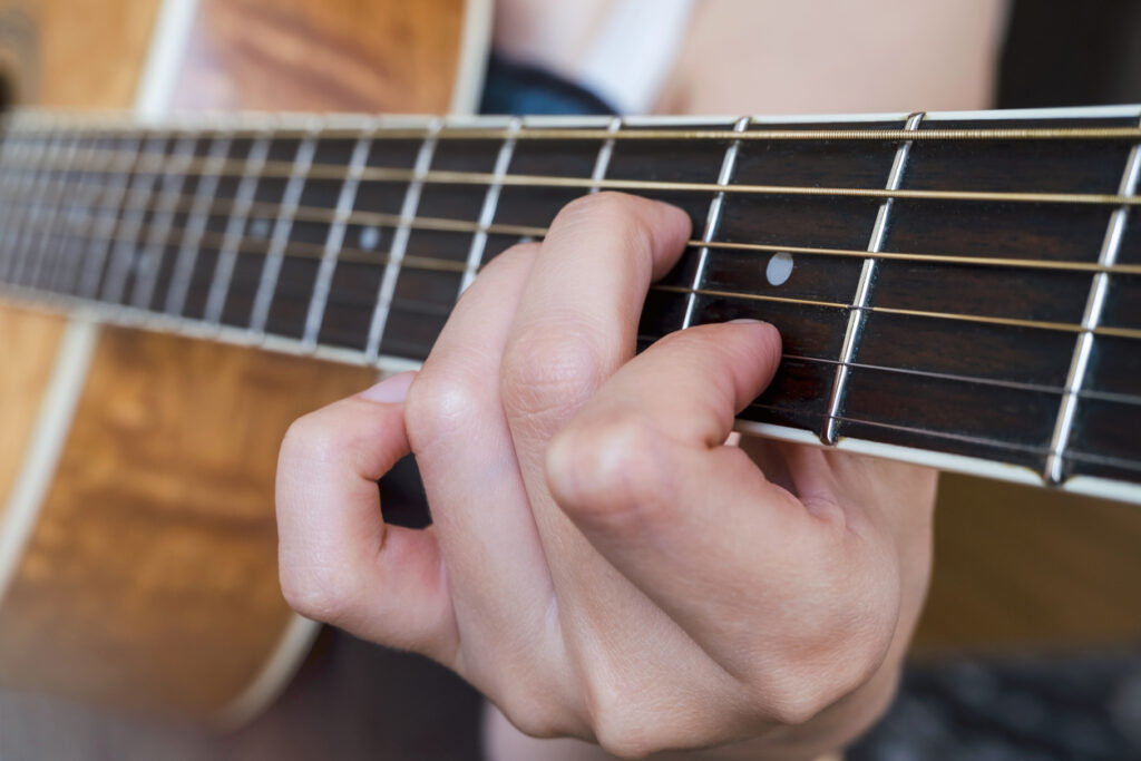 Guitarist doing finger exercises
